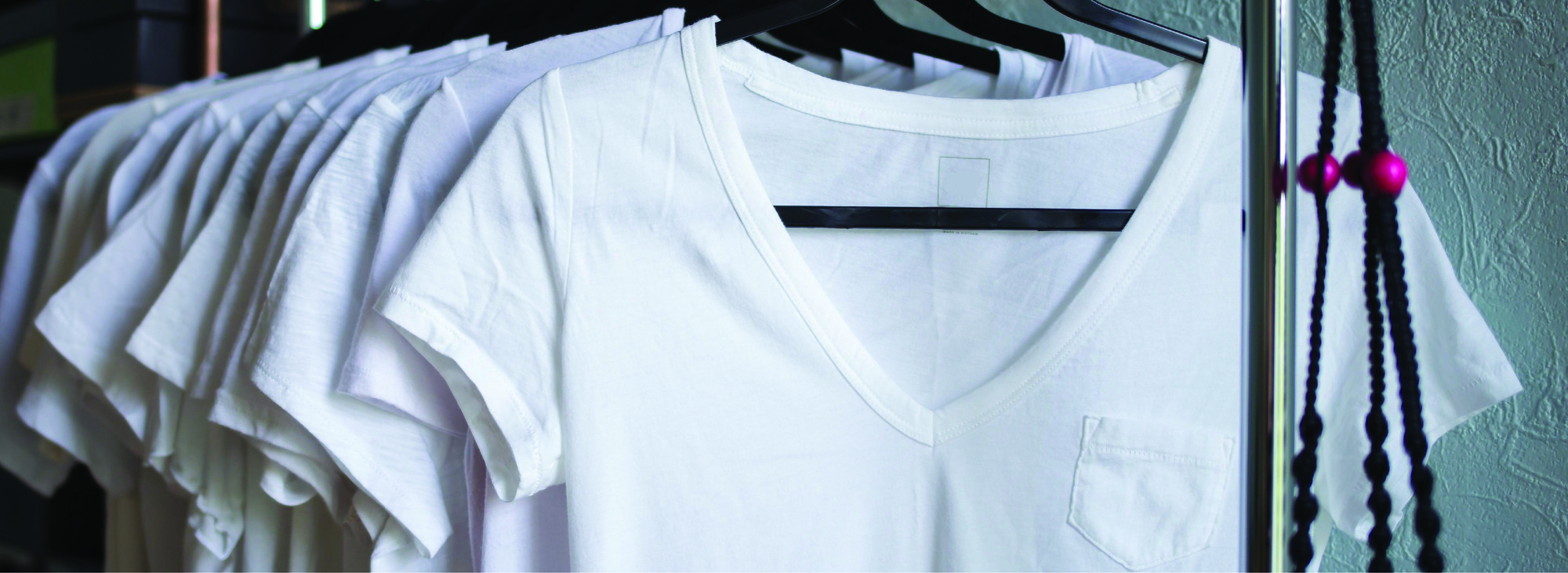 rack of white t shirts