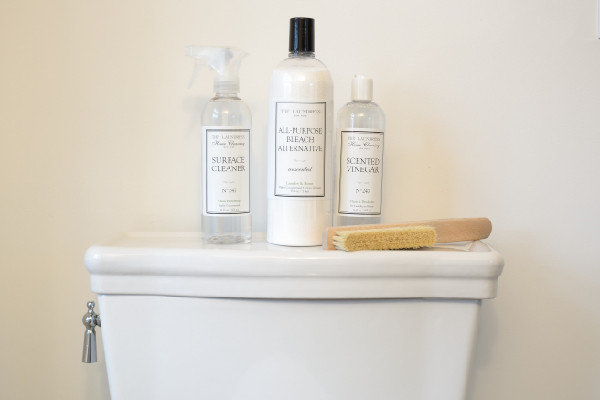 laundress products sitting on a toilet tank