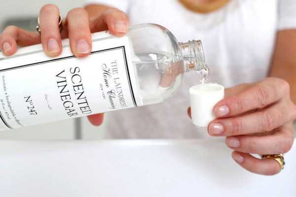 hand pouring scented vinegar