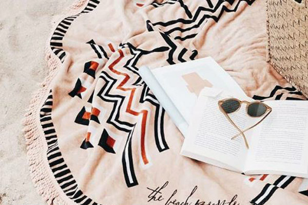beach towel with book and sunglasses