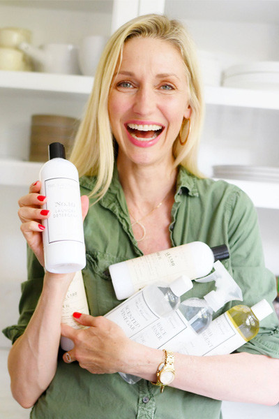 woman holding cleaning solutions