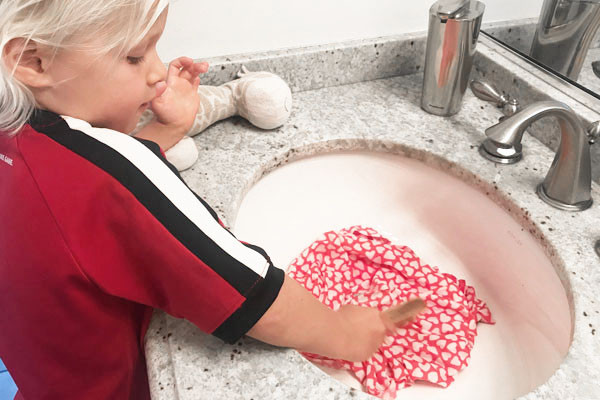 boy scrubbing stain