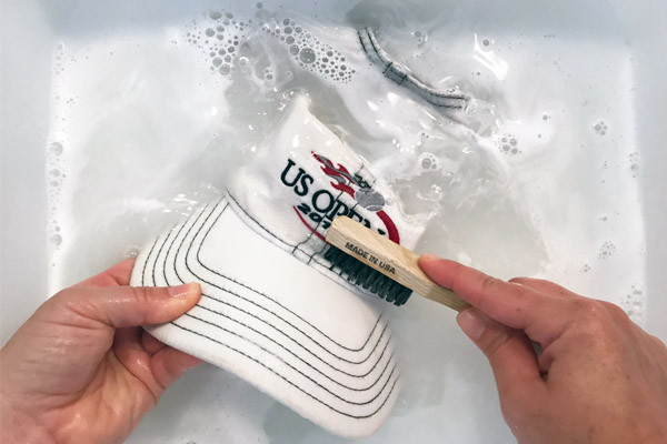 scrubbing cap soaking in bath of water