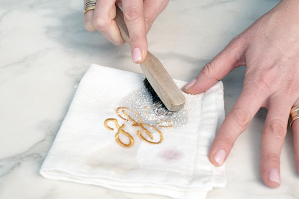 hand model removing stain from napkin with stain brush