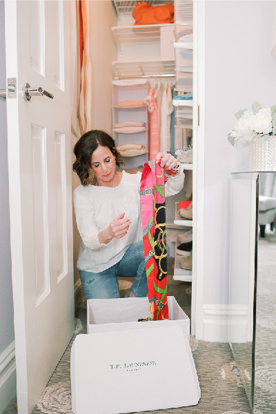 wendy putting items into laundress storage box